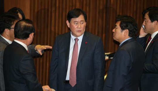 심각한 표정의 최경환 사진=연합뉴스. 최경환 부총리 겸 기획재정부 장관이 2일 오후 국회 본회의장에서 새해 예산안 등 처리를 위한 본회의가 열리기를 기다리며 굳은 표정으로 새누리당 의원들과 이야기하고 있다. 2015.12.2